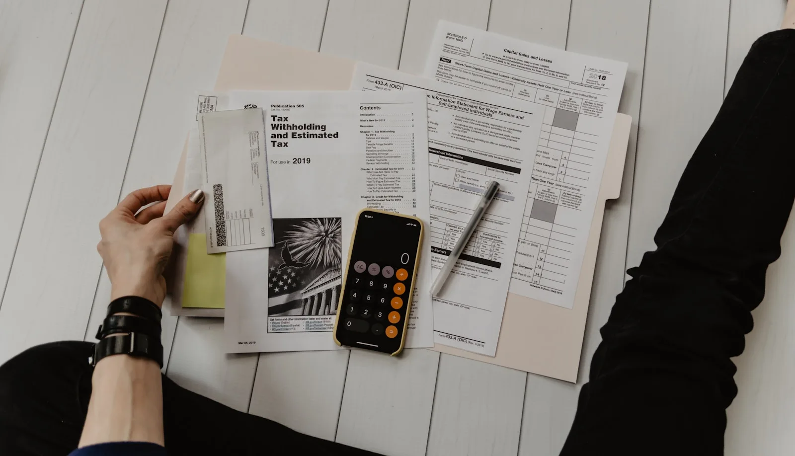 A calculator and receipts representing operating costs